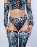 Model wearing the Meltdown High Waisted Thong with matching pieces, highlighting the high-rise waist and trippy smiley design.