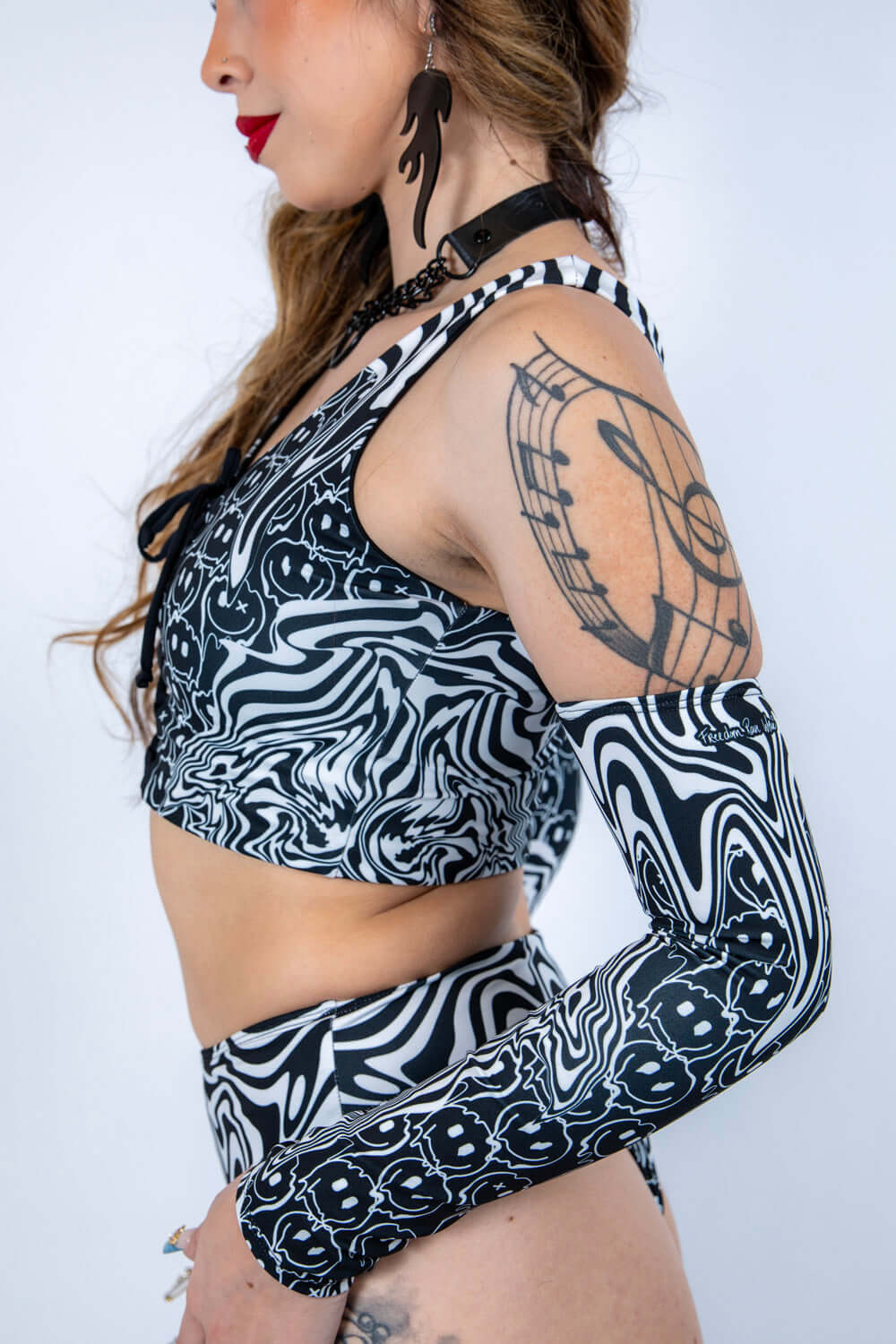 Side profile of the Meltdown Lace Up Top, showing the fit and design details with a focus on the sleeve and lace-up front.