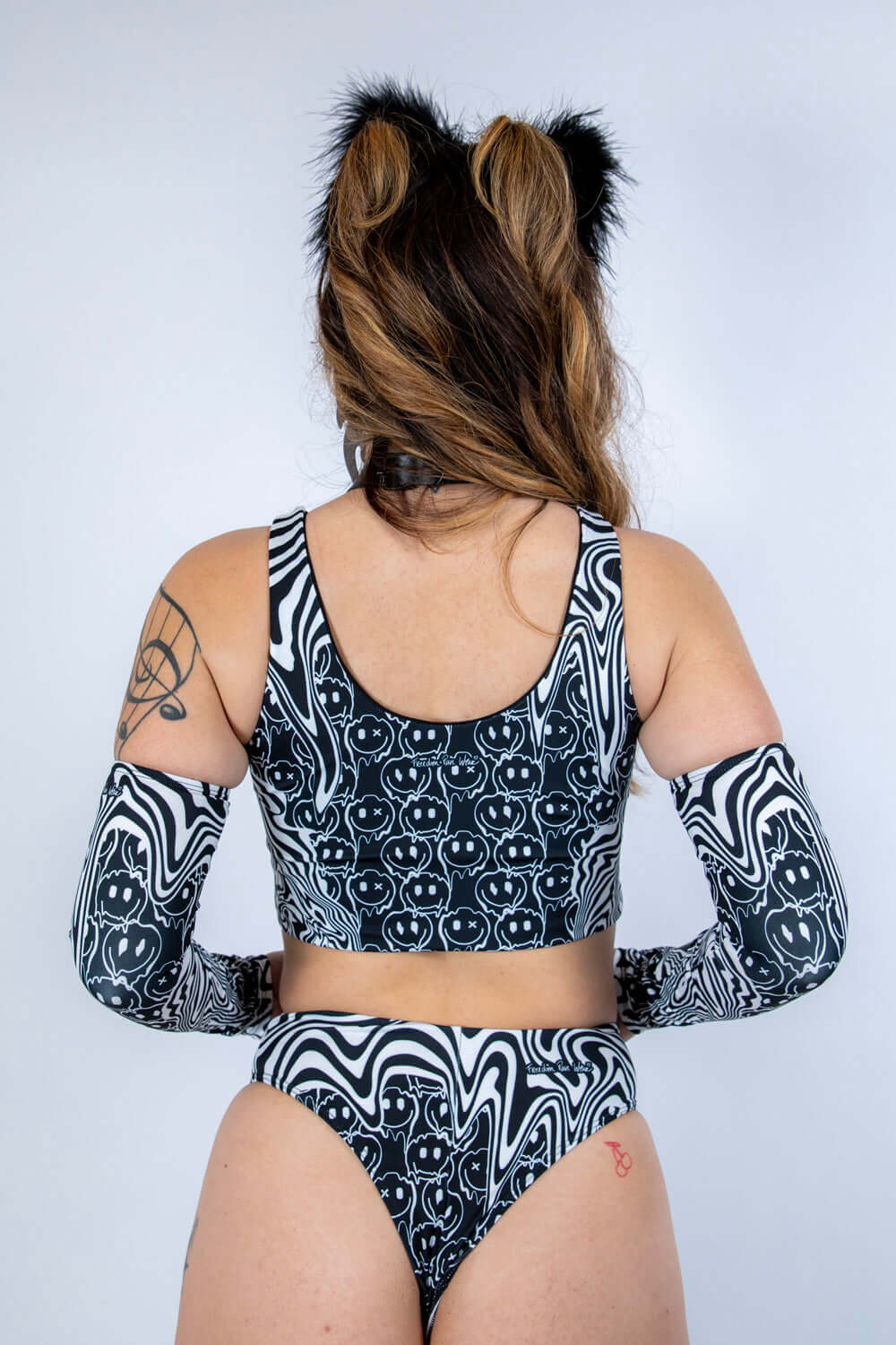Back view of the Meltdown Lace Up Top, showcasing the scoop back cut and melty trippy print across the shoulders.