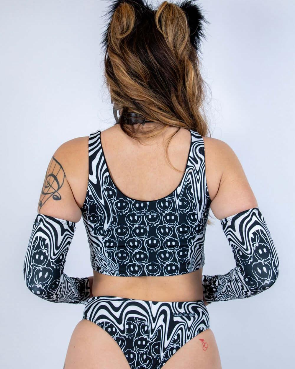 Back view of the Meltdown Lace Up Top, showcasing the scoop back cut and melty trippy print across the shoulders.