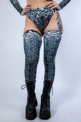Meltdown Leg Sleeves shown from the front with feet together, emphasizing the trippy print and full leg coverage.