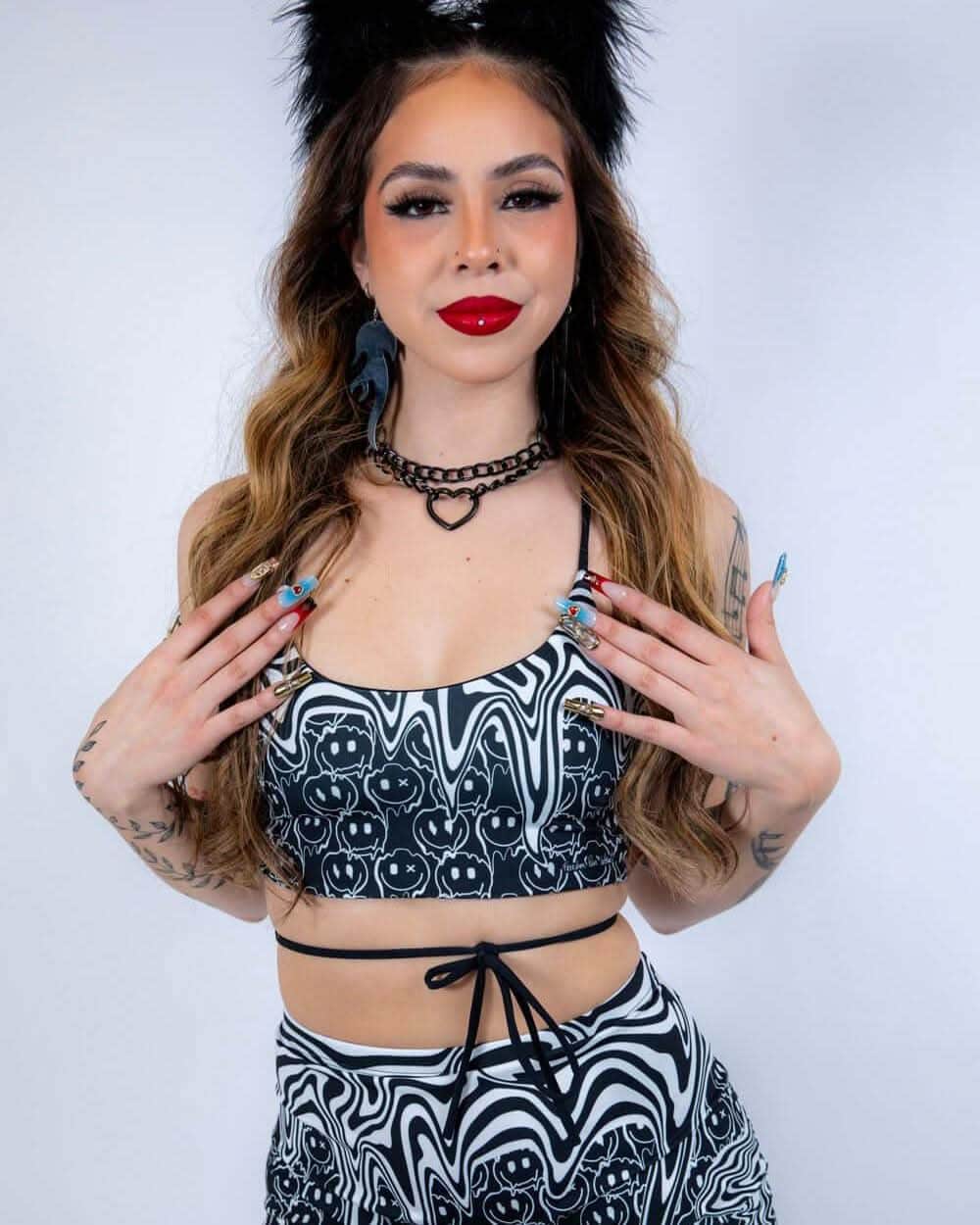 Model wearing black white Meltdown psychedelic rave top with matching bottoms front view festival outfit