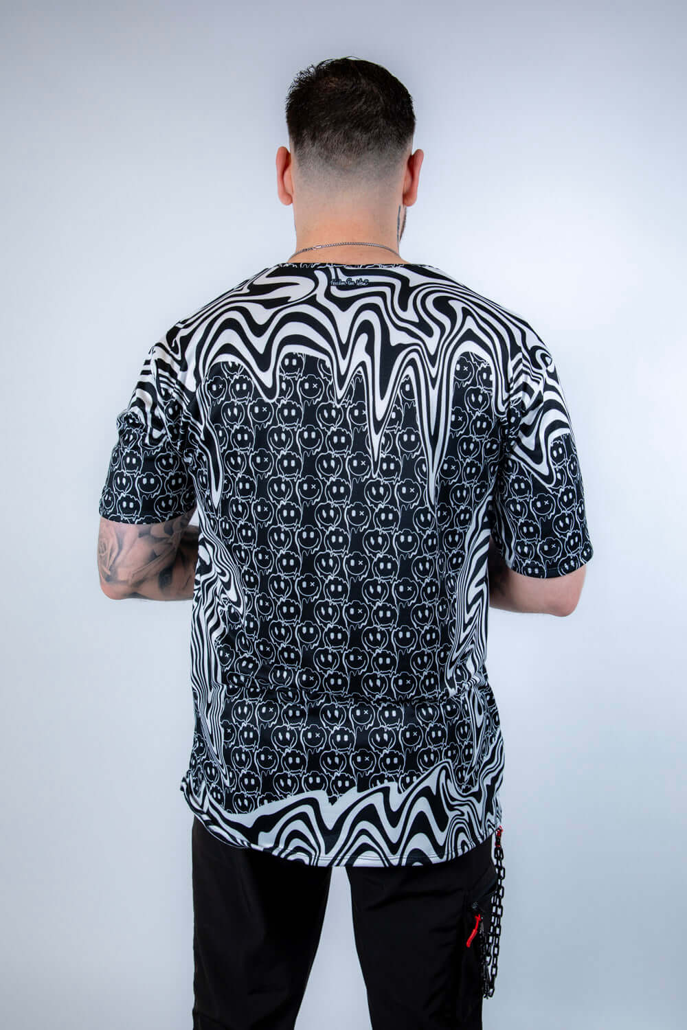 Back view of the Meltdown Oversized Softee, showcasing the full drape of the oversized fit and all-over trippy print.