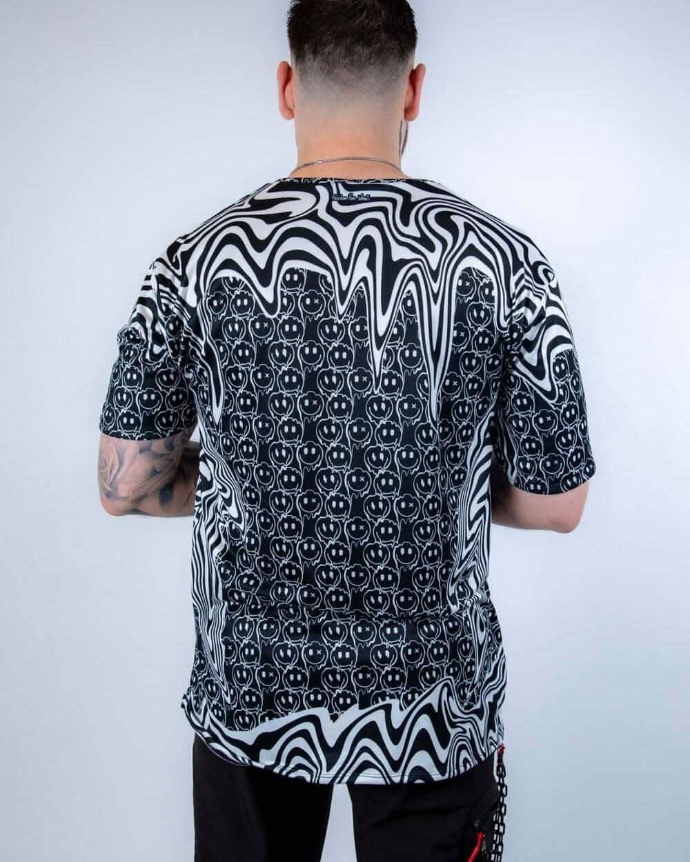 Back view of the Meltdown Oversized Softee, showcasing the full drape of the oversized fit and all-over trippy print.