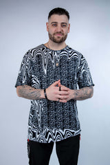 Model wearing the Meltdown Oversized Softee in a front-facing pose with hands clasped, showing off the relaxed fit and trippy smiley design.