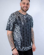 Male model wearing black white Meltdown oversized rave bodysuit style shirt festival outfit front view