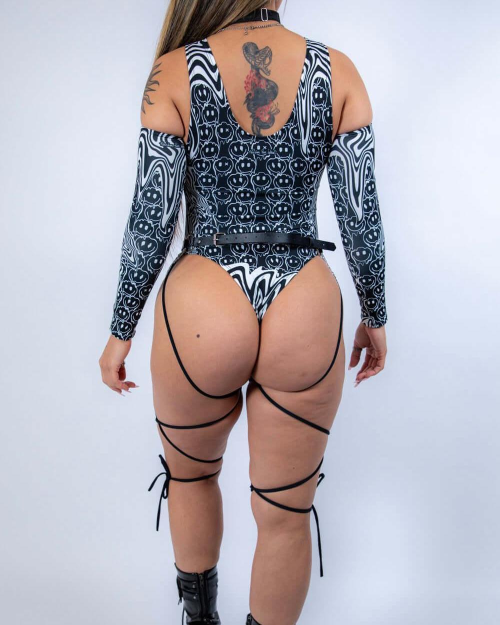 Rear view of the bodysuit with model standing tall, emphasizing strap details and full back design.