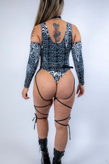 Rear view of the bodysuit with model standing tall, emphasizing strap details and full back design.