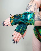 Mesozoic tropical print rave arm sleeves modeled with extended hands showing vibrant jungle pattern festival wear
