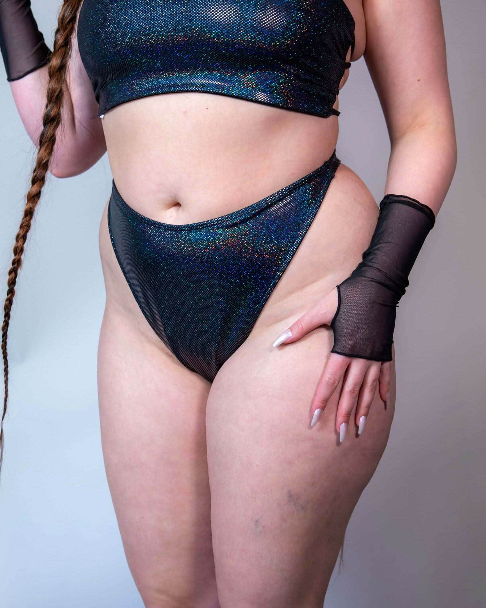 Model wearing Midnight holographic rave pants set with shimmery crop top and high-waisted bottoms for festival outfits