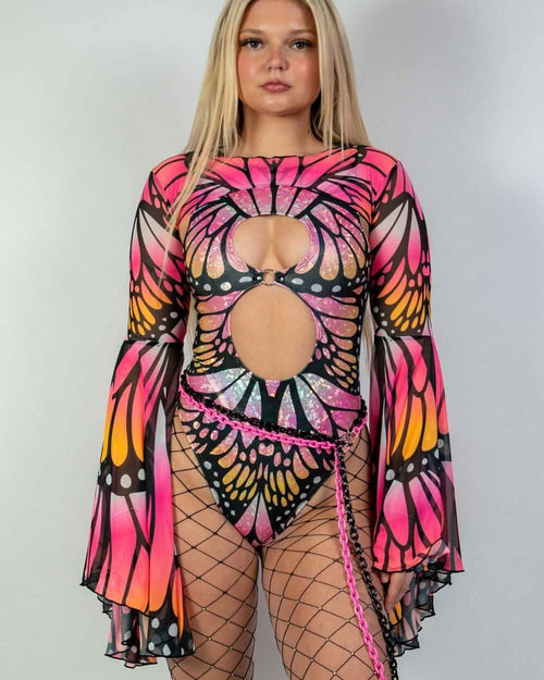 Model wearing a Monarch Keyhole Bodysuit in neon pink and orange butterfly design, perfect for rave outfits.