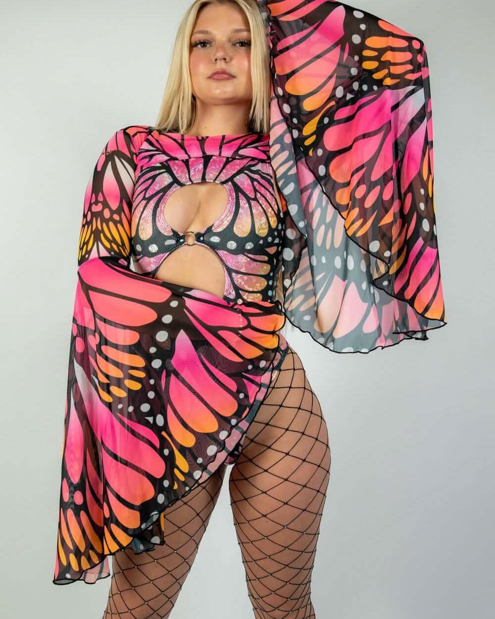 Model wearing vibrant Monarch Mesh Bell Sleeves with butterfly print, styled for rave outfits and eye-catching appeal.