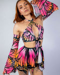 Model showcasing Monarch Metamorphosis Sleeves with vibrant butterfly print, ideal for rave outfits and stylish events.