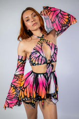 Model showcasing Monarch Metamorphosis Sleeves with vibrant butterfly print, ideal for rave outfits and stylish events.