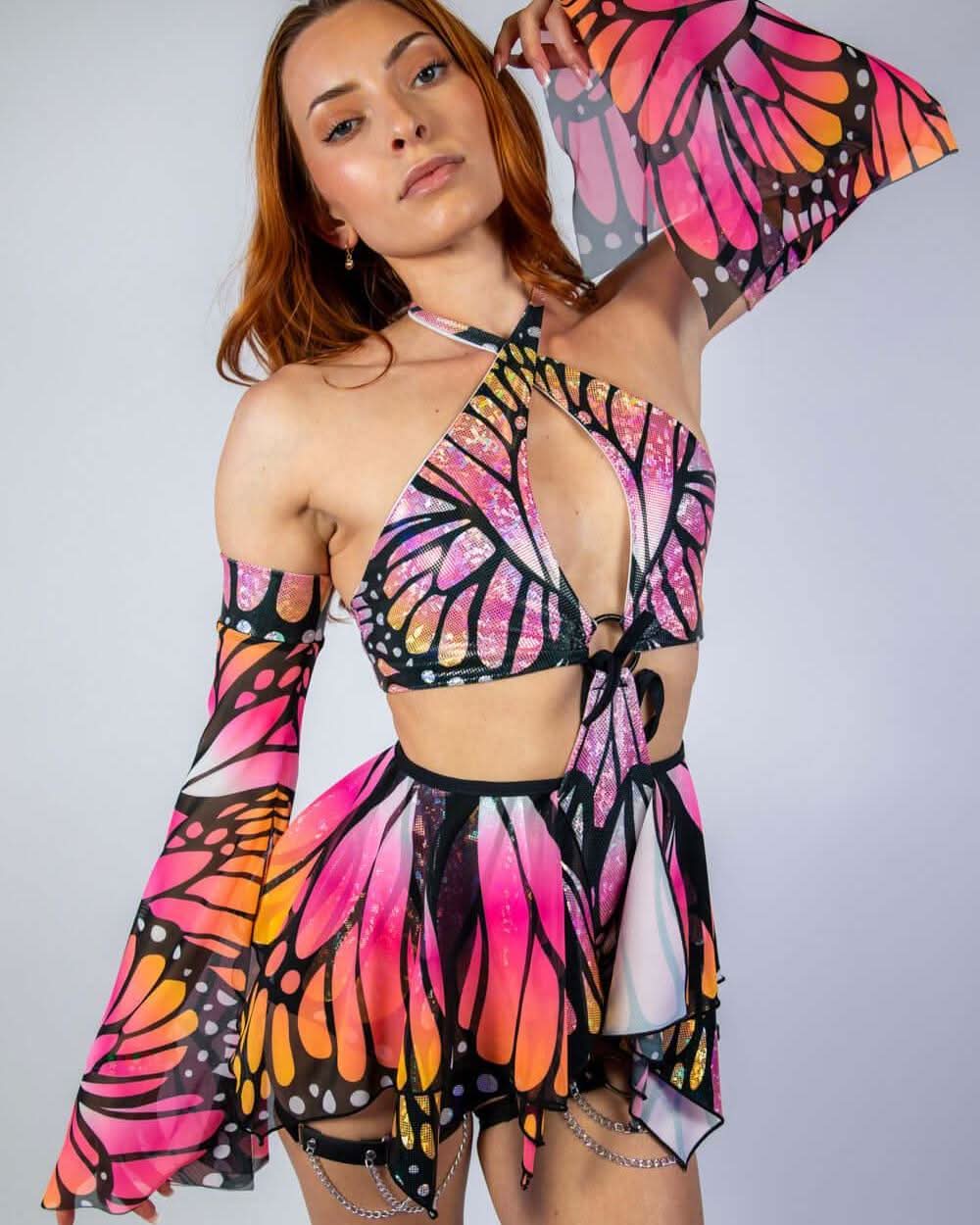 Model showcasing Monarch Metamorphosis Sleeves with vibrant butterfly print, ideal for rave outfits and stylish events.