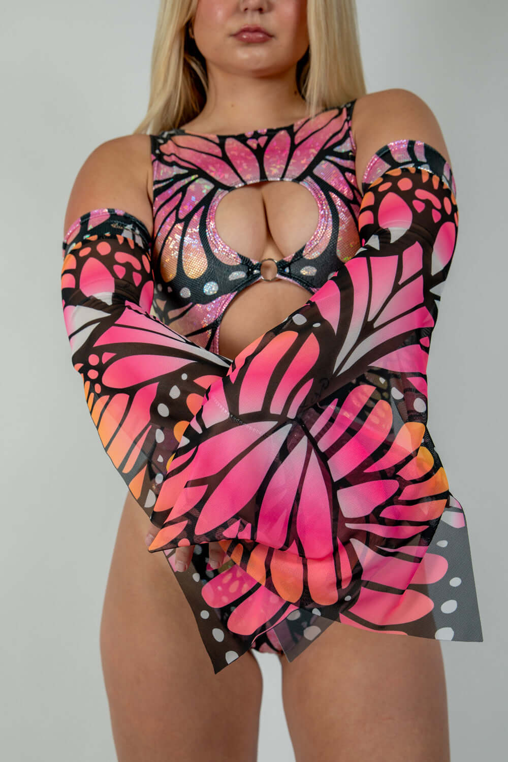 Woman modeling Monarch Metamorphosis Sleeves with butterfly design, perfect for rave outfits and clothing.