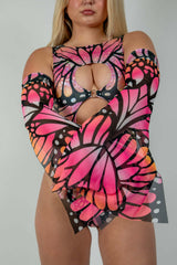 Woman modeling Monarch Metamorphosis Sleeves with butterfly design, perfect for rave outfits and clothing.