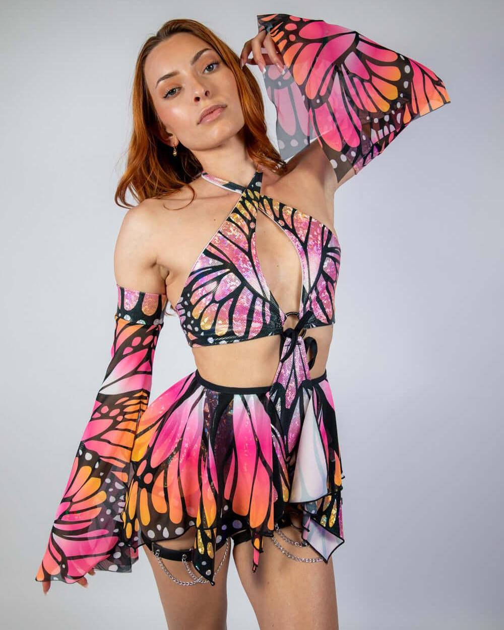 Model wearing a vibrant Monarch O-Ring Bodysuit with butterfly wings, showcasing a stylish rave outfit.
