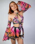 Model wearing a vibrant Monarch O-Ring Bodysuit with butterfly wings, showcasing a stylish rave outfit.