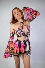 Model wearing a vibrant Monarch O-Ring Bodysuit with butterfly wings, showcasing a stylish rave outfit.