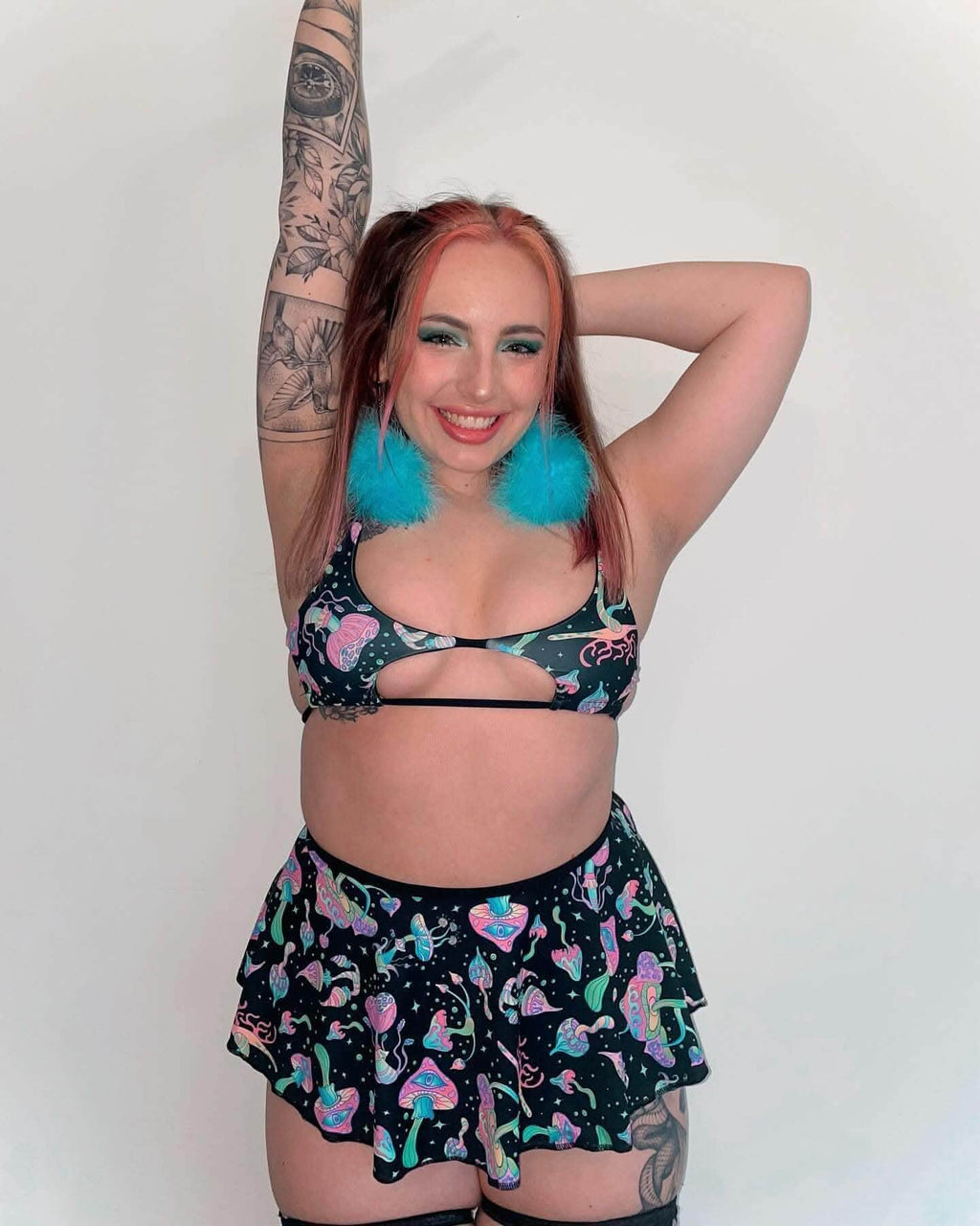 Model wearing Mushies Wonder Top with tie straps and a matching skirt, showcasing vibrant mushroom print and rave style.