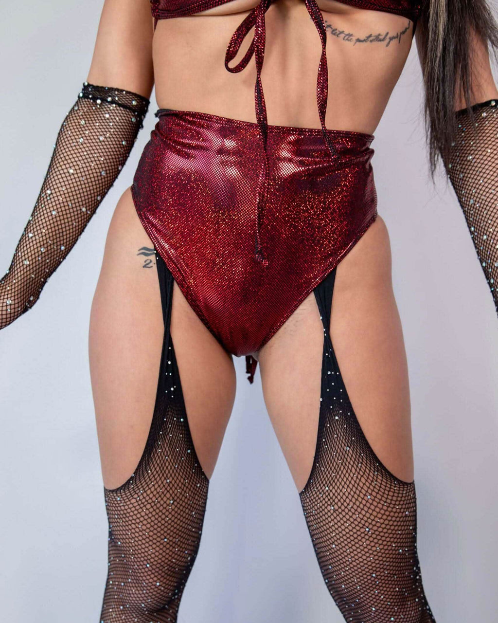 Phoenix High Waisted Bikini Bottoms in red sparkle, paired with fishnet gloves, perfect for rave outfits.