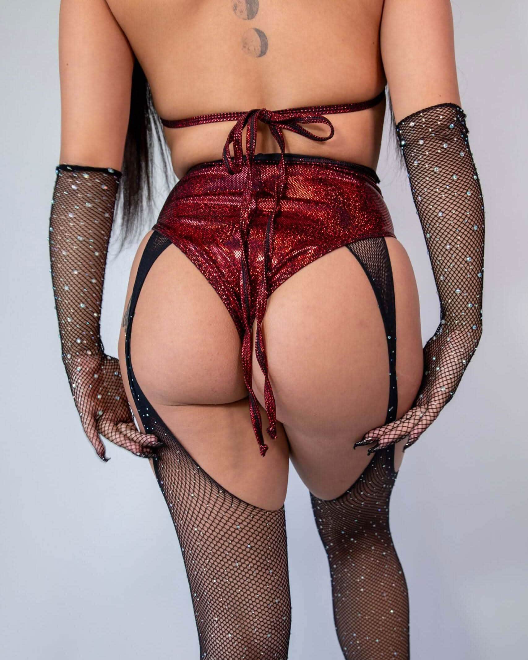 Phoenix high waisted rave pants in red sparkly fabric - back view with black fishnet stockings for festival outfit
