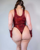 Back view of a model wearing the Phoenix Keyhole Bodysuit in sparkly red, perfect for rave outfits and stylish events.