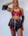 Red sparkly crop top paired with a black skirt featuring chain details, perfect for rave outfits and stylish events.