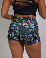 Poison high waist shorts with skulls and plants, perfect for rave outfits, showcasing a flattering fit and bold design.