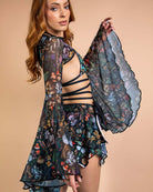 Model showcasing Poison Mesh Bell Sleeves with skull and floral print, perfect for rave outfits and festivals.