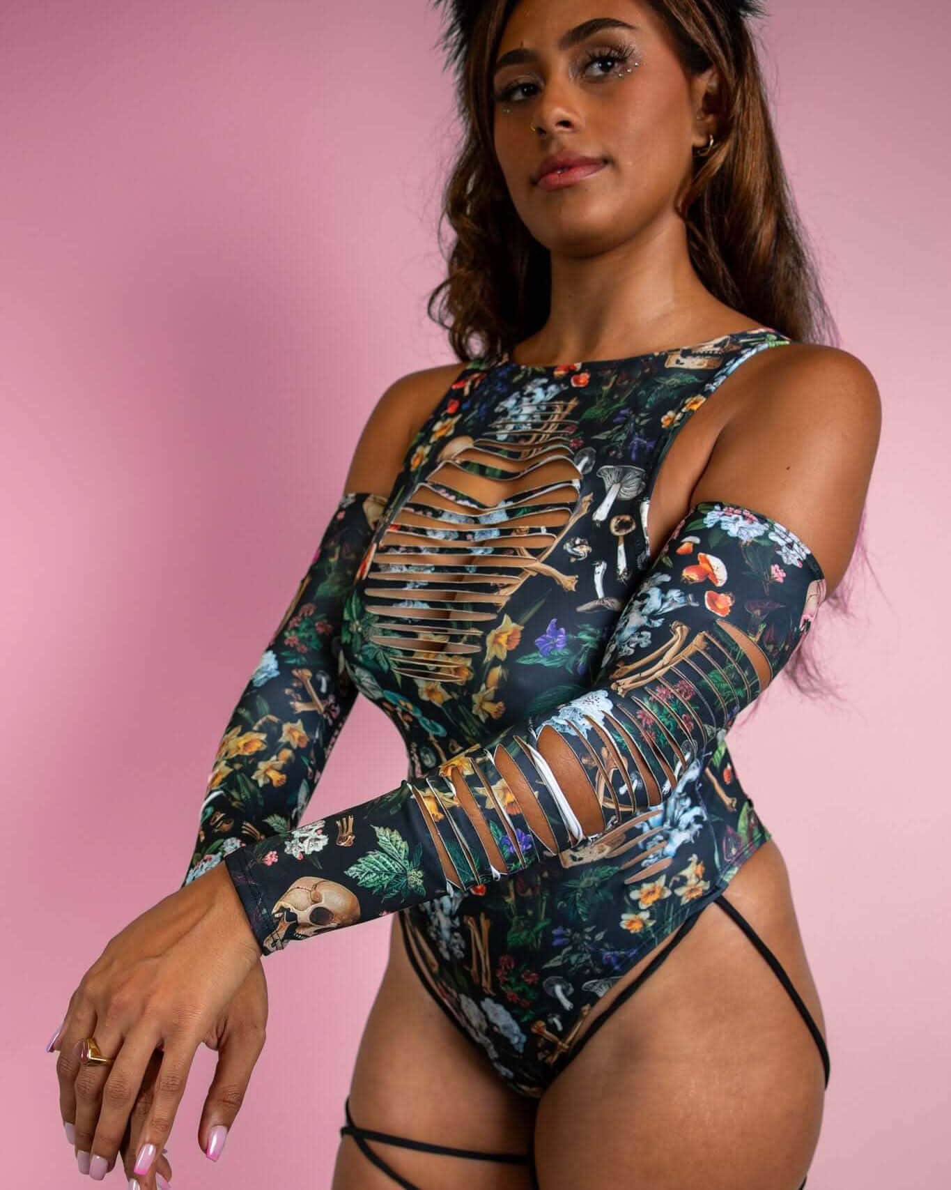 Model showcasing Poison Slit Arm Sleeves with bold skulls and mushroom print, perfect for rave outfits and edgy festival looks.