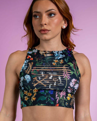 Poison Slit Crop Top with bold floral and skull print, perfect for edgy rave outfits, featuring unique slit details.
