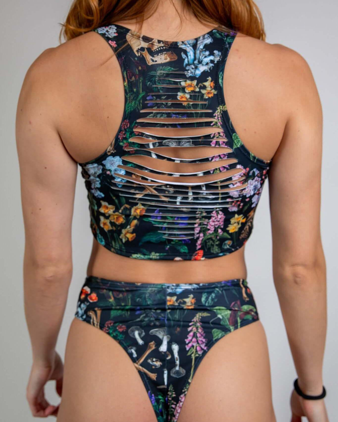 Poison Slit Crop Top showcasing edgy slit details and vibrant floral print, perfect for rave outfits.