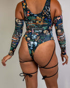 Poison Slit Sideboob Bodysuit with leg straps, featuring a vibrant skull and floral print, perfect for rave outfits.
