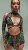 Video of model dancing in a vibrant psychedelic bodysuit with bell sleeves and cut-out details from Freedom Rave Wear, paired with eye-catching boots.