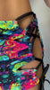 Video of Model wearing Freedom Rave Wear's psychedelic set with a crisscross top and matching skirt, featuring vibrant, colorful patterns. Includes matching arm warmers for a bold rave look.