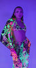 Model wearing vibrant neon rave outfit featuring a matching bikini and cover-up, perfect for festivals.