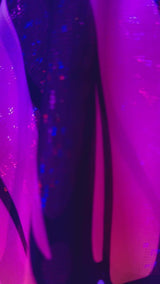 Close-up of vibrant purple and black fabric showcasing a UV reactive design, perfect for rave outfits and clothing.