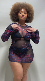 Video showcasing a model in a StarFlora floral mesh dress by Freedom Rave Wear, highlighting the design and fabric movement.