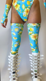 Video of a floral rave outfit from Freedom Rave Wear: blue and yellow high-waisted bottoms, matching thigh-high leggings, and white platform boots.