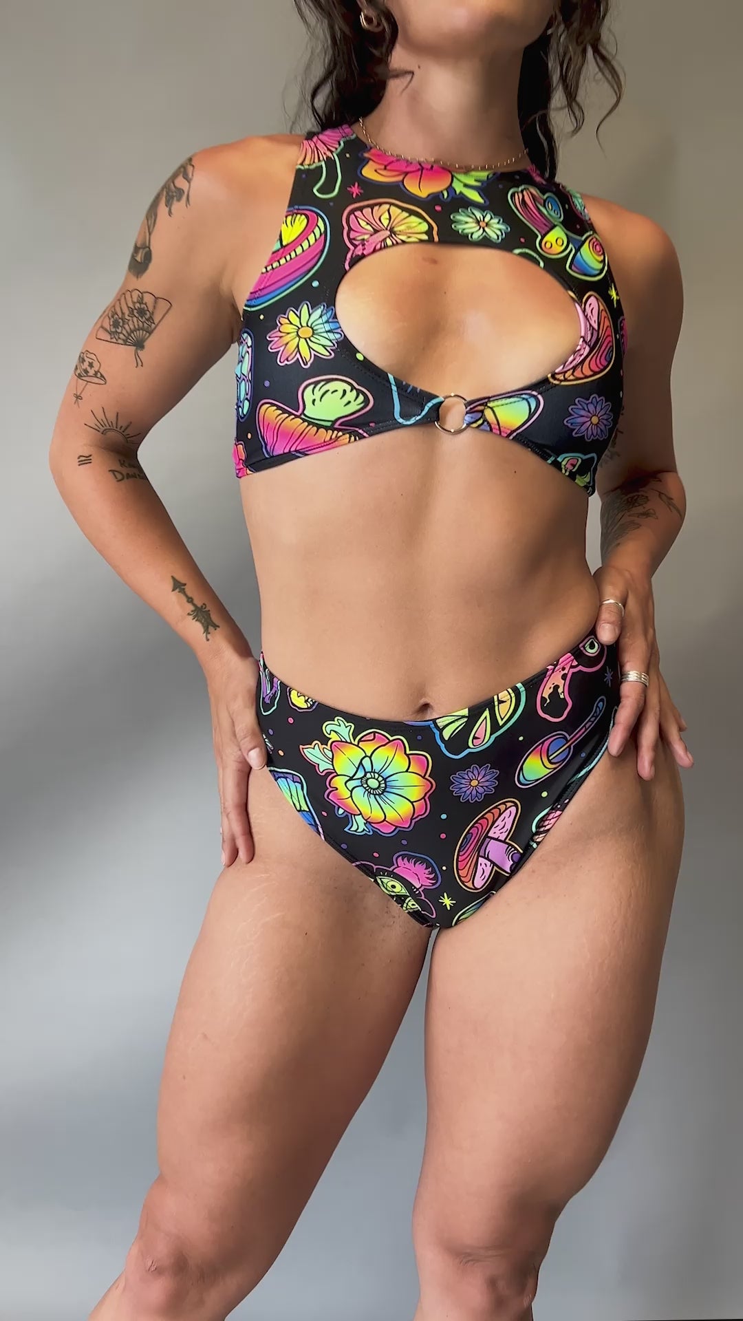 Video of Freedom Rave Wear high-waisted rave bottoms showcasing psychedelic floral and mushroom patterns. Paired with matching top.