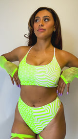 Video of a woman in a Freedom Rave Wear outfit with green and white psychedelic patterns, featuring a high-waisted design.