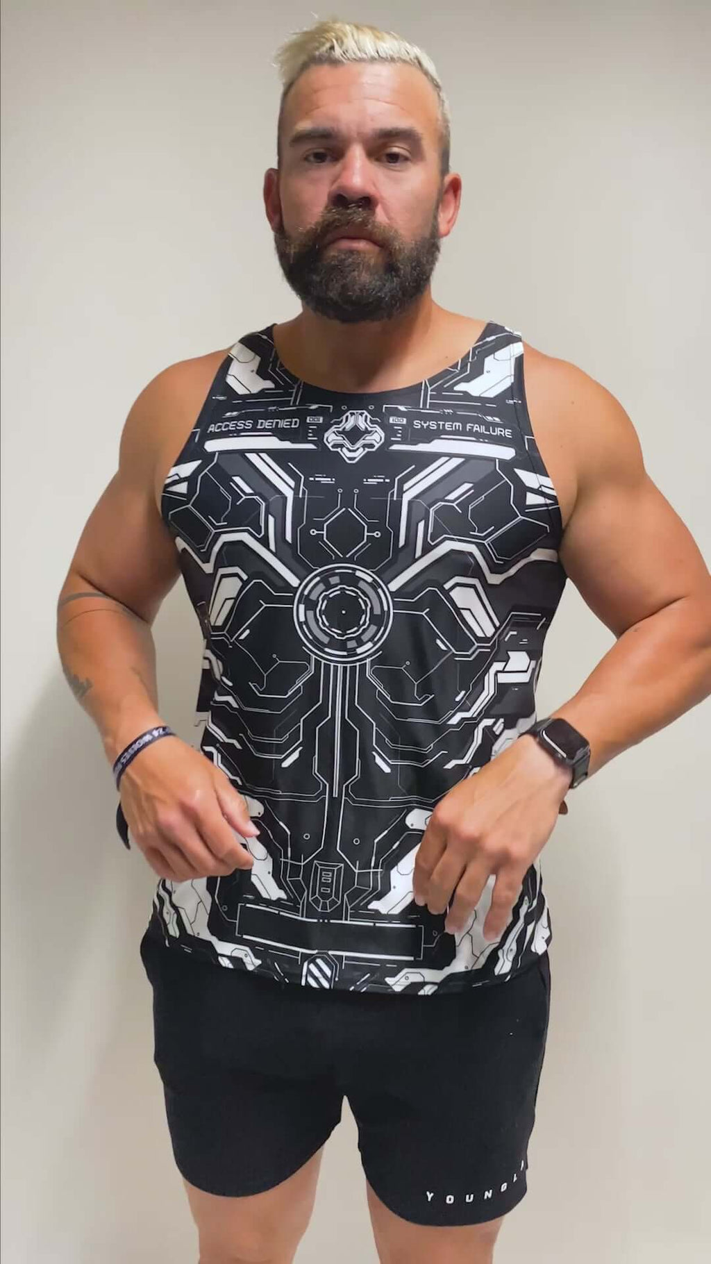 Model wearing a black and white tech-themed tank top with circuit patterns, perfect for raves. Freedom Rave Wear offers unique festival fashion.