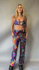 Video of Model in Freedom Rave Wear’s psychedelic crop top and wide-leg pants, featuring vibrant, trippy designs. Ideal for standout rave and festival outfits.