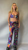 Video of Model in Freedom Rave Wear’s psychedelic crop top and wide-leg pants, featuring vibrant, trippy designs. Ideal for standout rave and festival outfits.