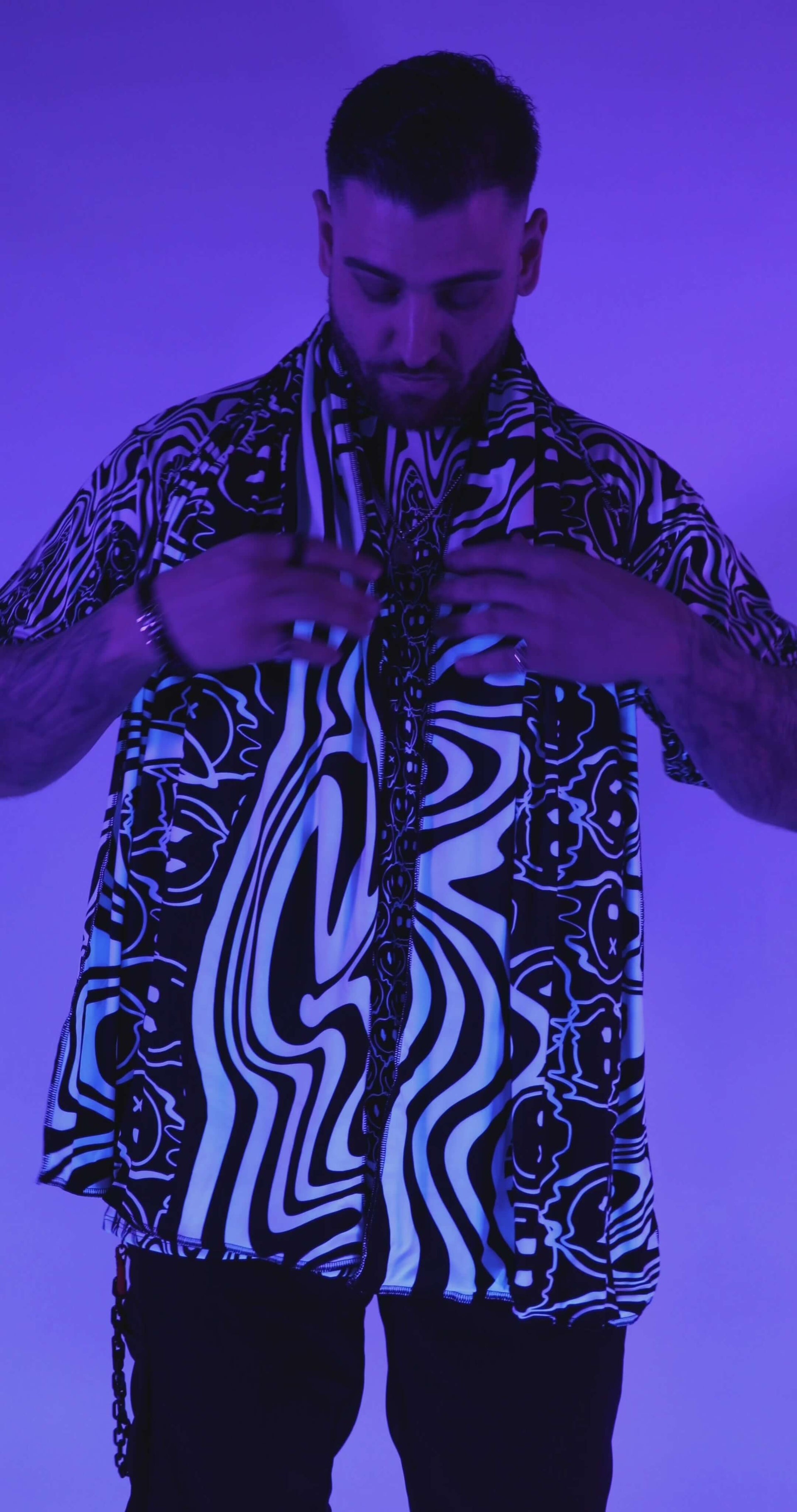 Meltdown Festival Scarf under blacklight, highlighting its UV-reactive trippy pattern in a bold, glowing effect.