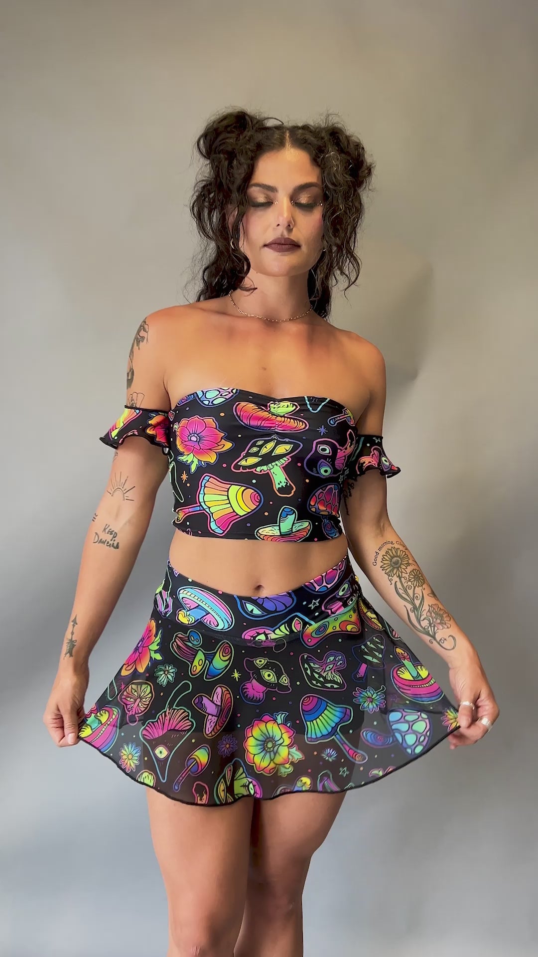 Video of Freedom Rave Wear sheer mini skirt with vibrant psychedelic mushroom prints, perfectly pairs with matching tops for rave outfits.