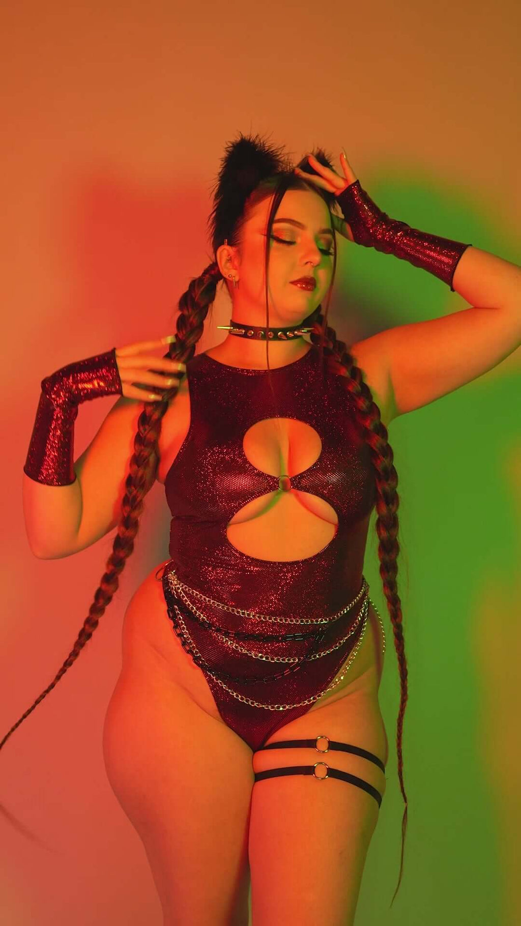 Model wearing the Phoenix Keyhole Bodysuit in fiery red, featuring cutout details and a bold design, perfect for rave and festival outfits.