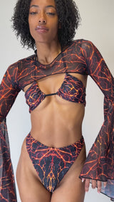 Freedom Rave Wear lava print rave bikini set with a mesh bell-sleeve top. A bold, fiery look perfect for rave events and festivals.